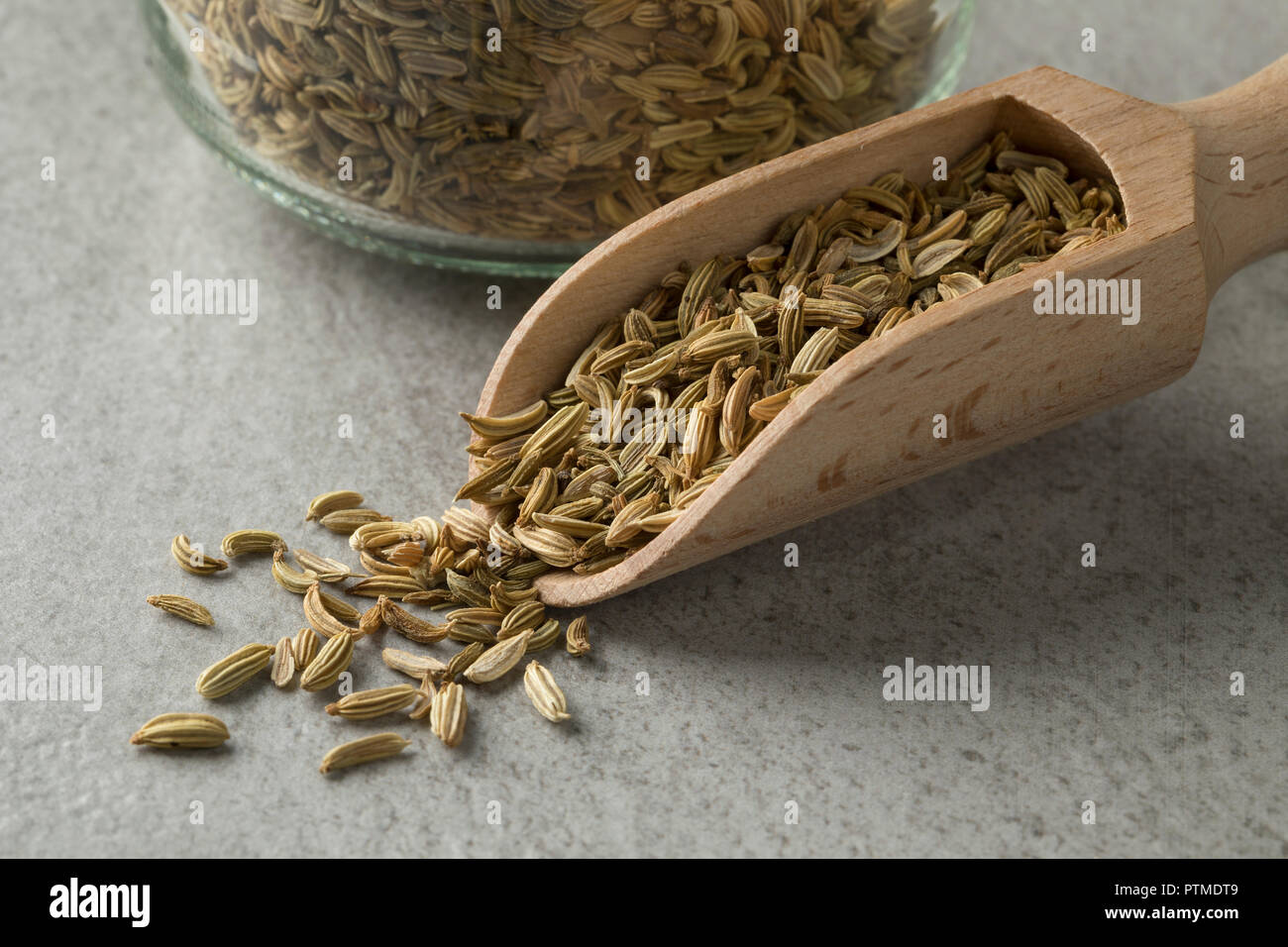 Heap of fennel seeds on a wooden spoon closeup Stock Photo