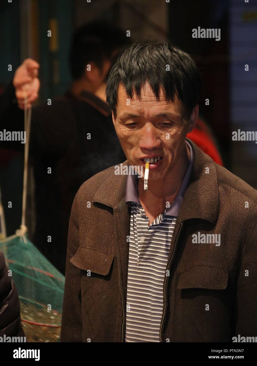 Chinese man on a street market Stock Photo
