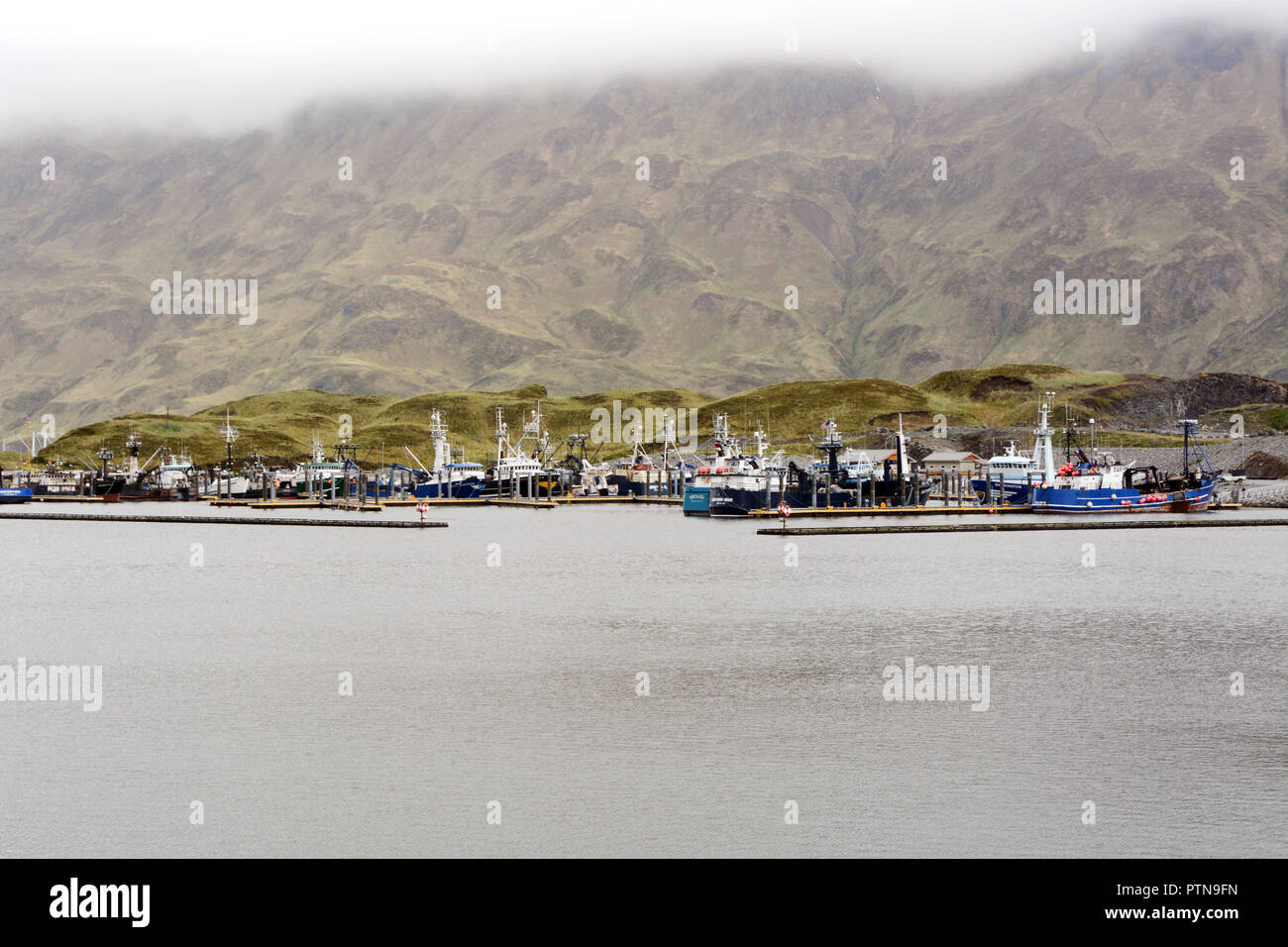 Big commercial fishing boats docked at a marina in Dutch Harbor, on Amaknak Island (Unalaska), in the Aleutian Islands chain, Alaska, United States. Stock Photo