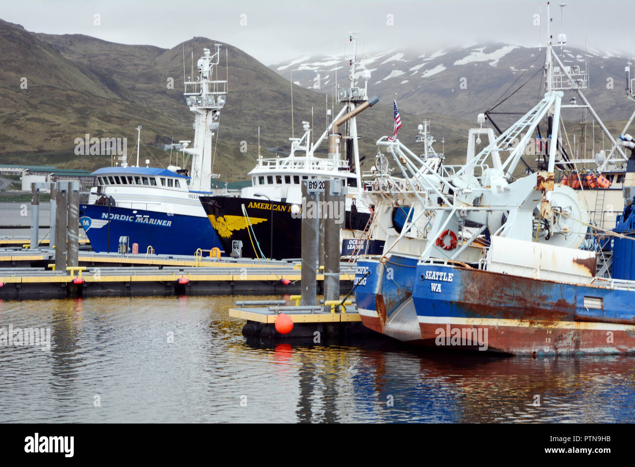 Big commercial fishing boats docked at a marina in Dutch Harbor, on Amaknak Island (Unalaska), in the Aleutian Islands chain, Alaska, United States. Stock Photo
