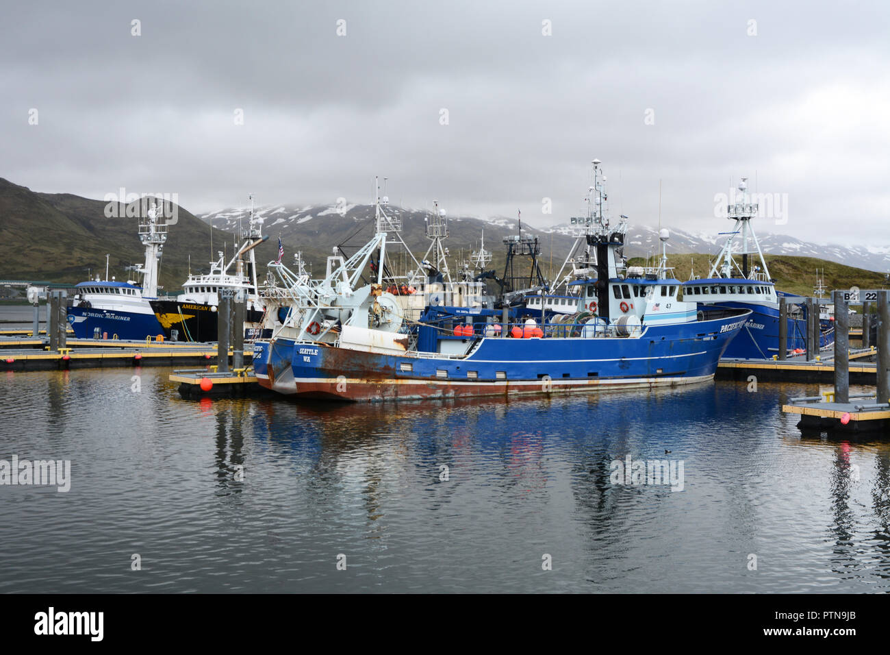 Big commercial fishing boats docked at a marina in Dutch Harbor, on Amaknak Island (Unalaska), in the Aleutian Islands chain, Alaska, United States. Stock Photo