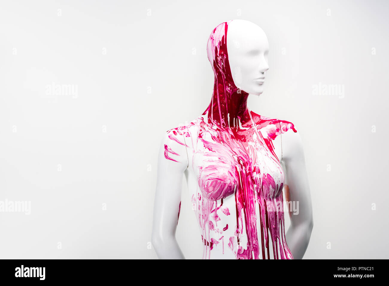 white female mannequin in red paint isolated on white Stock 