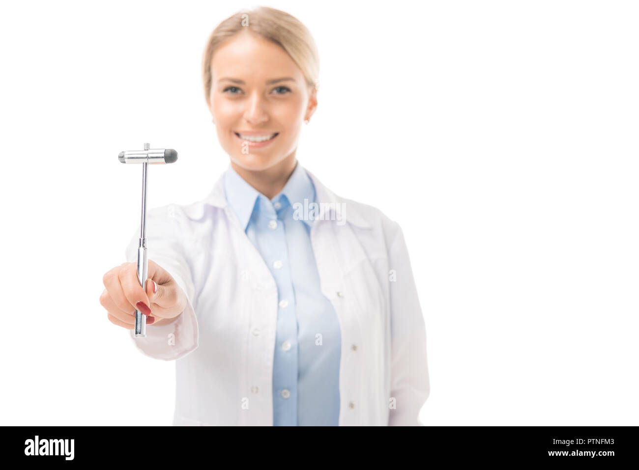 smiling young female neurologist holding reflex hammer and looking at camera isolated on white Stock Photo