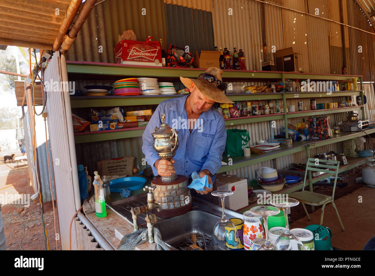 Trainer Craig Wnedt prepares the winning trophy for the horse races at Landor, 1000km north of Perth, Western Australia. Stock Photo