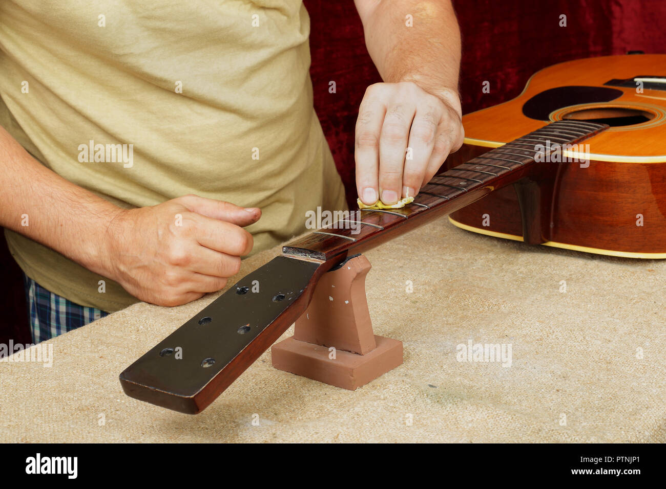 Tempering Musical Instruments Musical instrument guitar repair and service - Worker moistening and ...