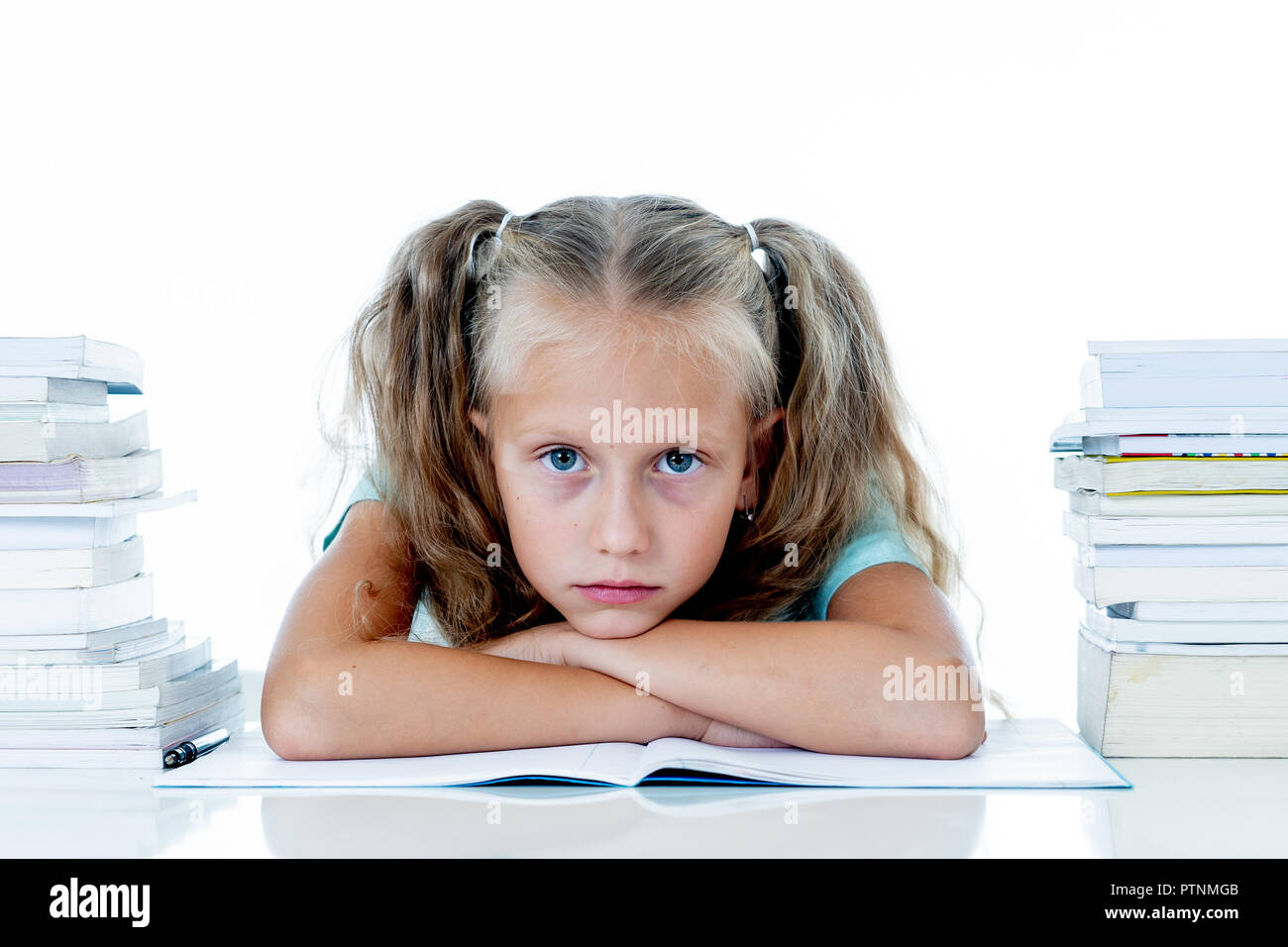 Frustrated little schoolgirl feeling a failure unable to concentrate in reading and writing difficulties learning problem attentional disorders specia Stock Photo