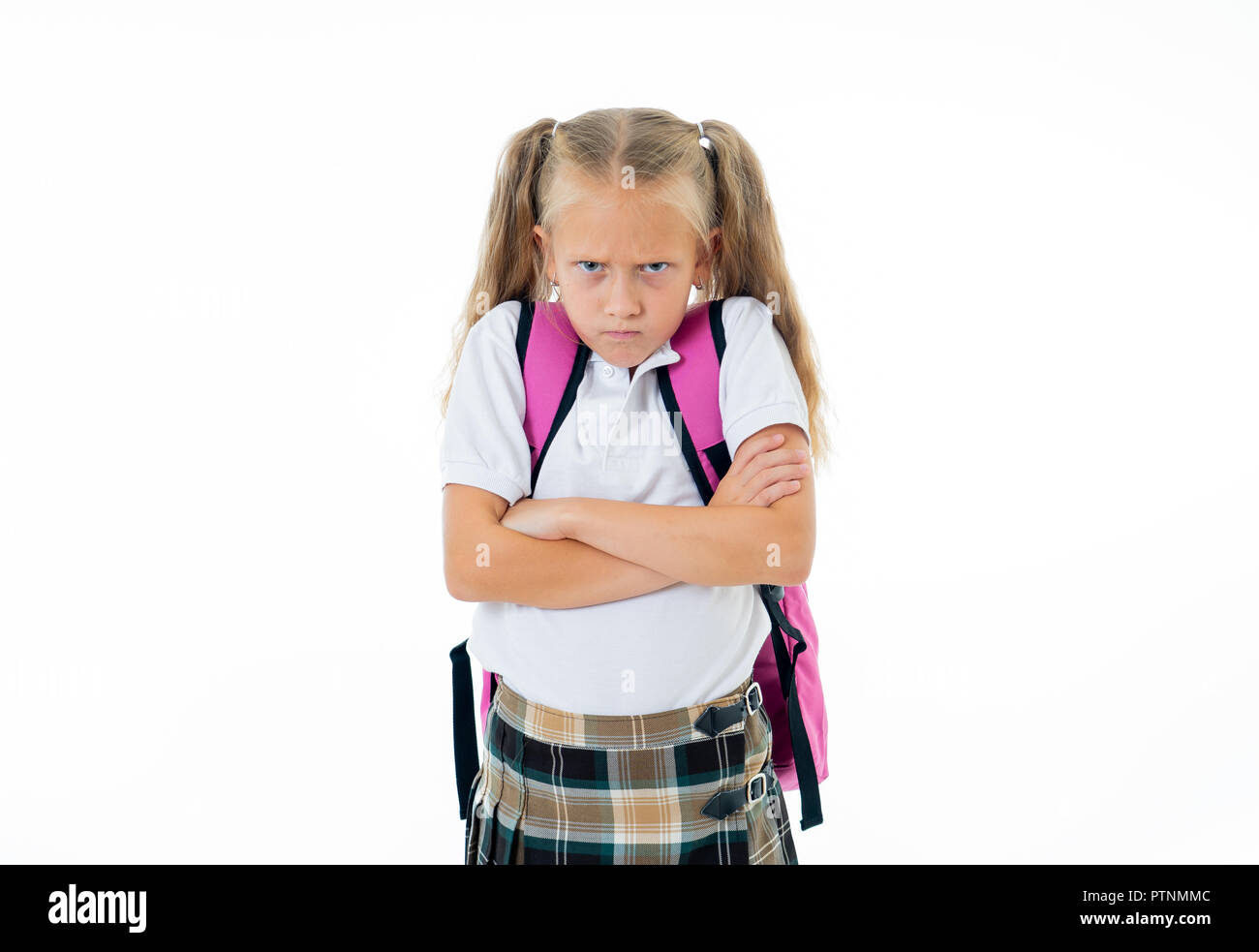 Sweet beautiful little girl in school uniform feeling angry and