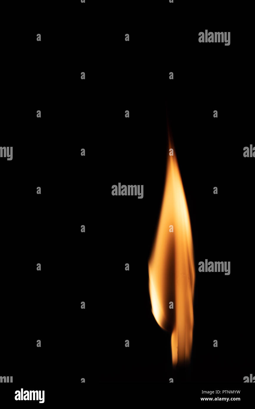 Match with strongly flaring flame on a black background closeup Stock Photo