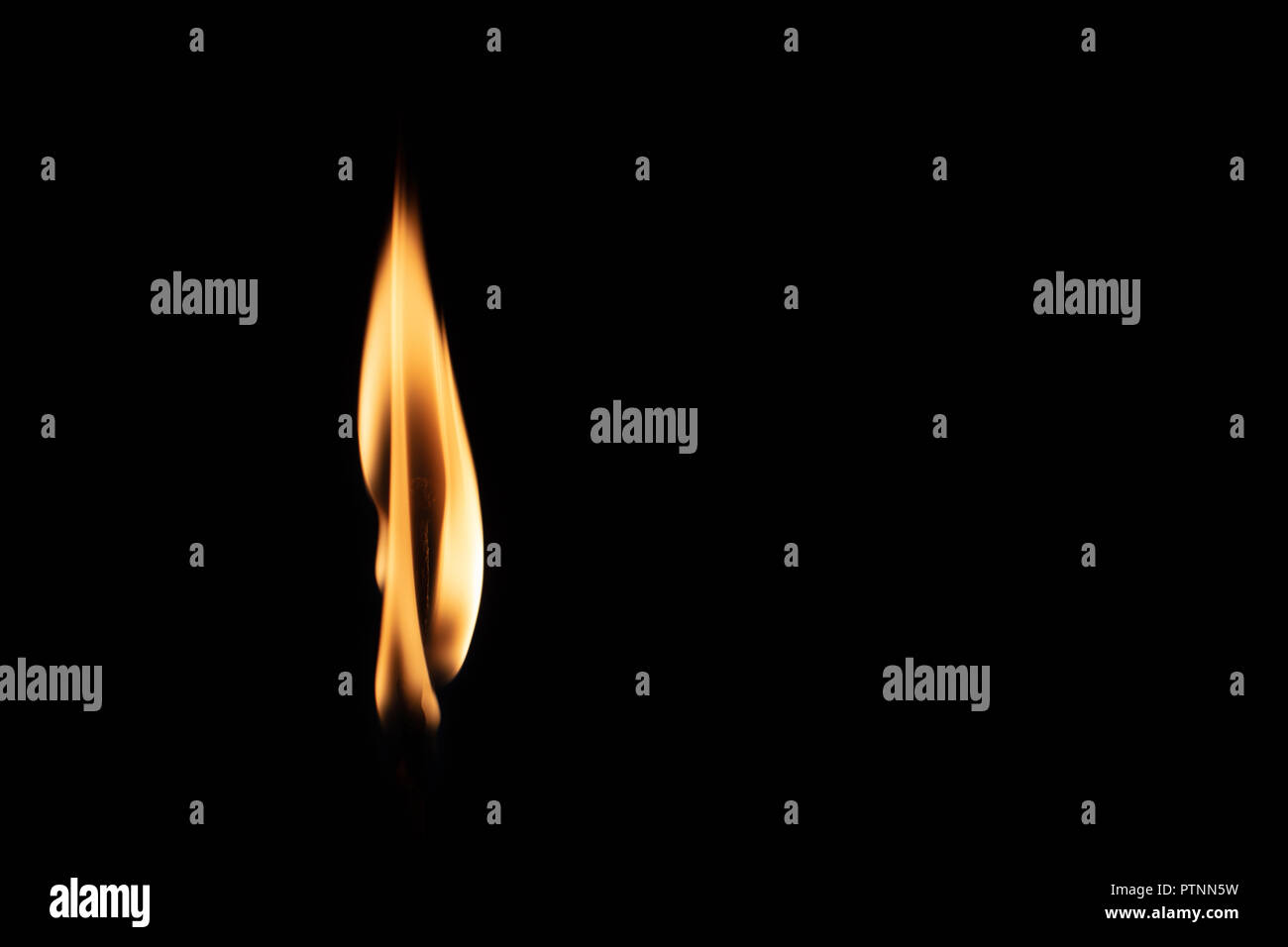 Match with strongly flaring flame on a black background closeup Stock Photo