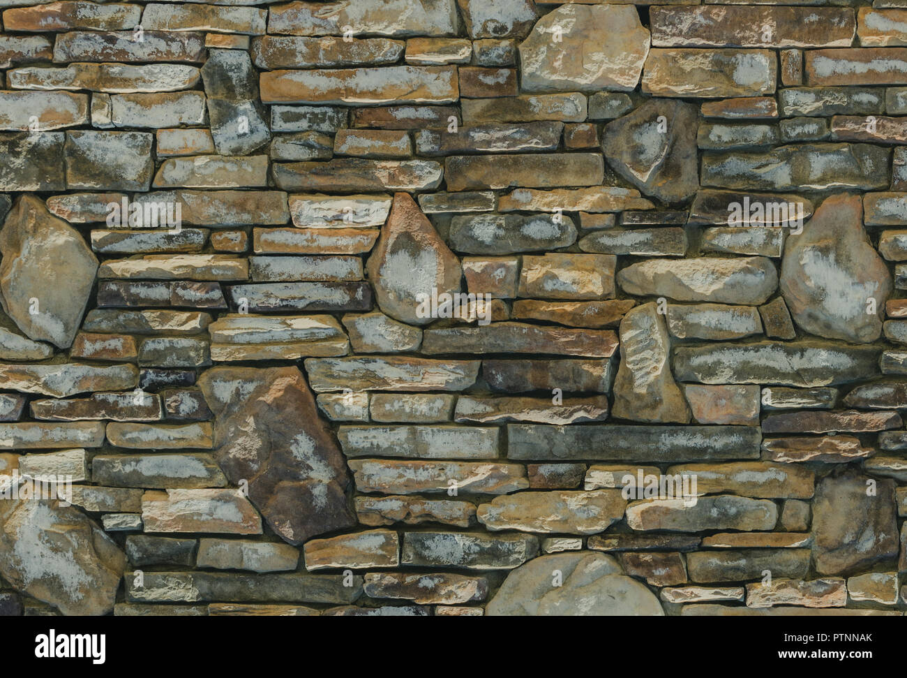 Interesting loose rock wall for background or text. Stock Photo
