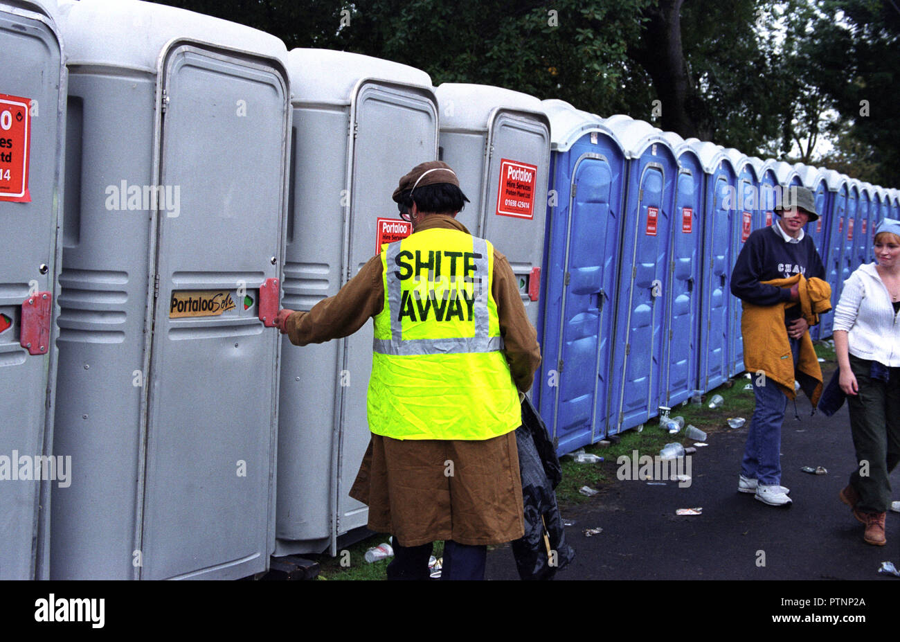 A toilet attendant cleaning out thetoilets at pop festival somewhere and wearing a rather cheeky vest! Alan Wylie/ALAMY © Stock Photo