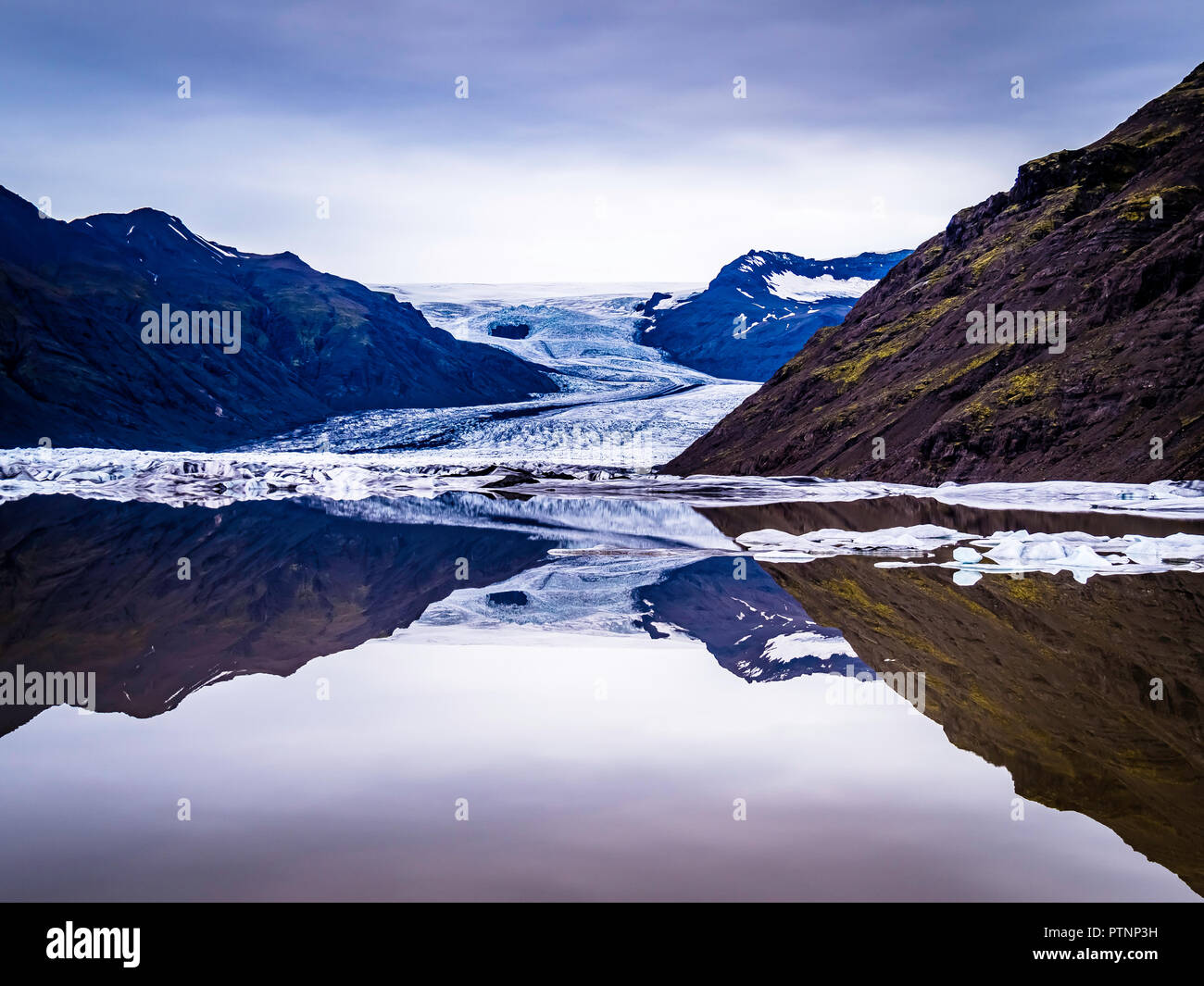 Clear reflection of the glacier and mountain in Glacier Lagoon Iceland Stock Photo