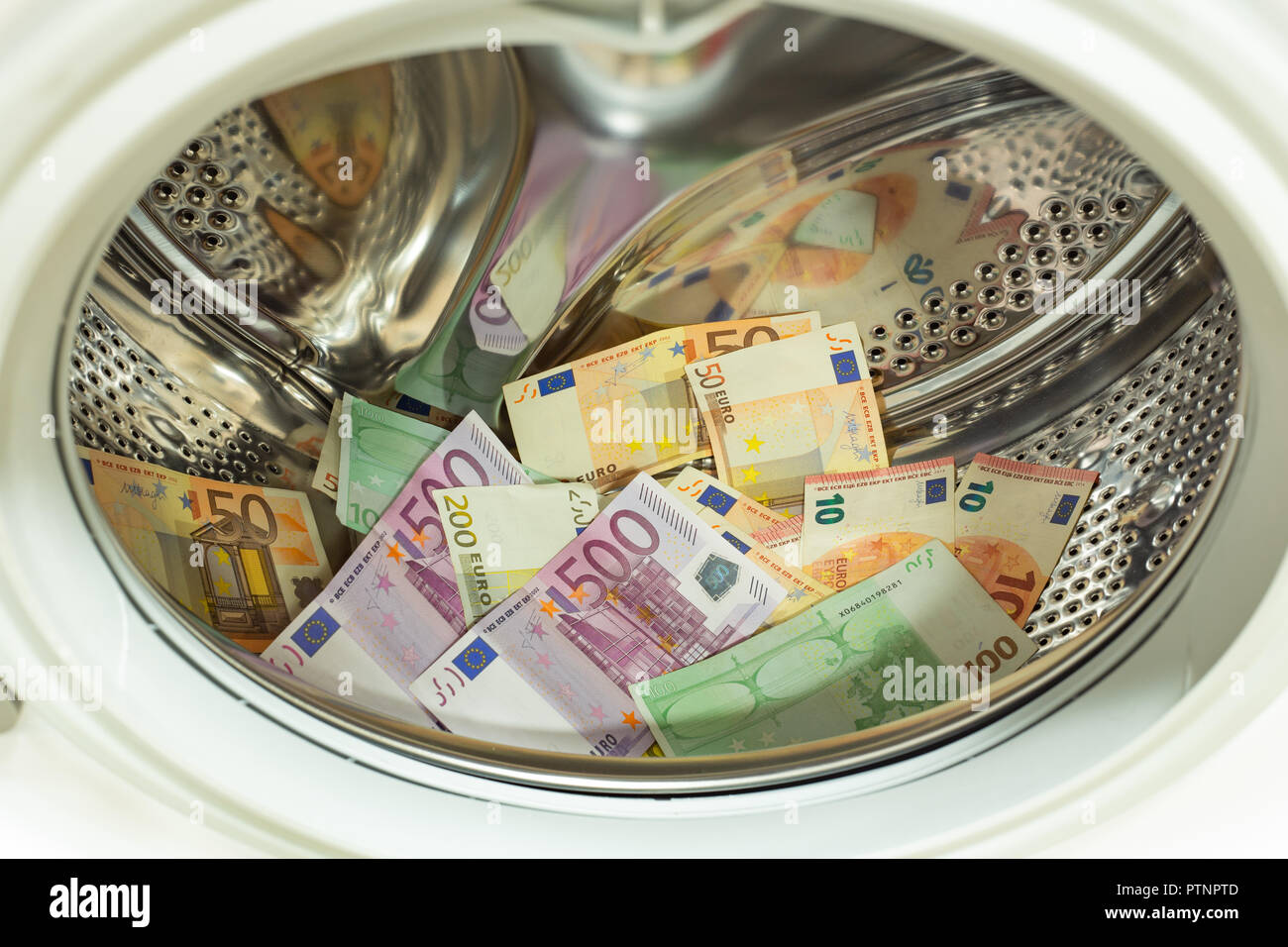 Euro / European currency, high denomination in the washing machine. Money laundering concept Stock Photo
