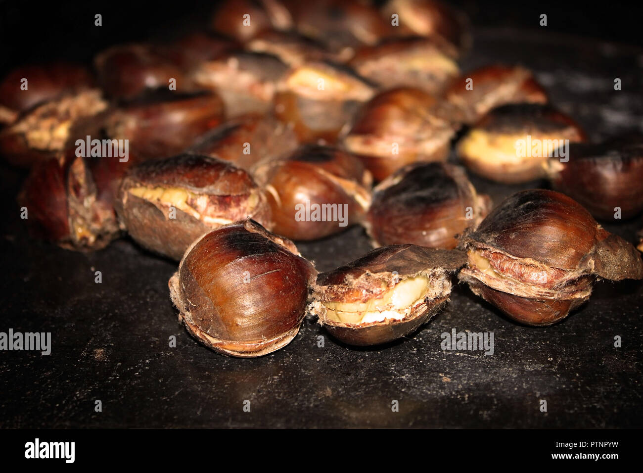 Chestnuts roasting on top of a traditional Lebanese stove called sobia