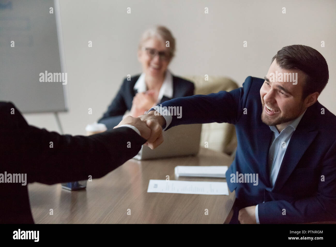Close up of excited colleague giving fists bump for success Stock Photo