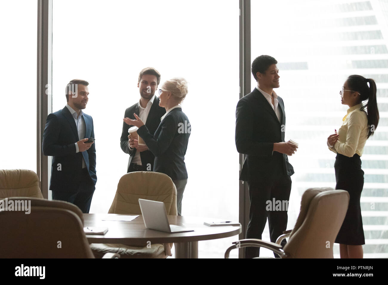 Colleagues having casual talk during work break in office Stock Photo -  Alamy
