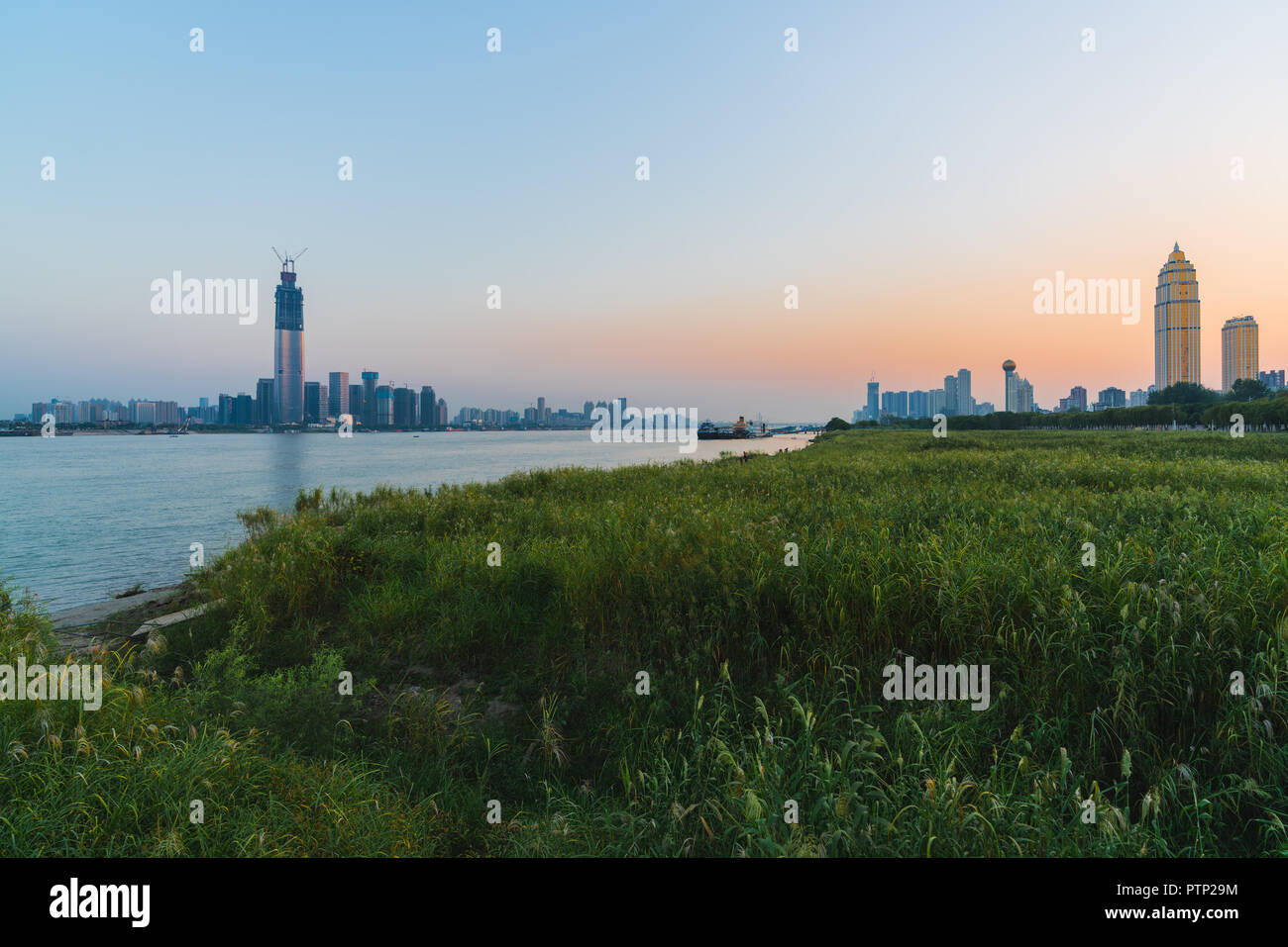 Wuhan riverbank scenery with both Yangtze riverside skyline at sunset in Wuhan Hubei China Stock Photo