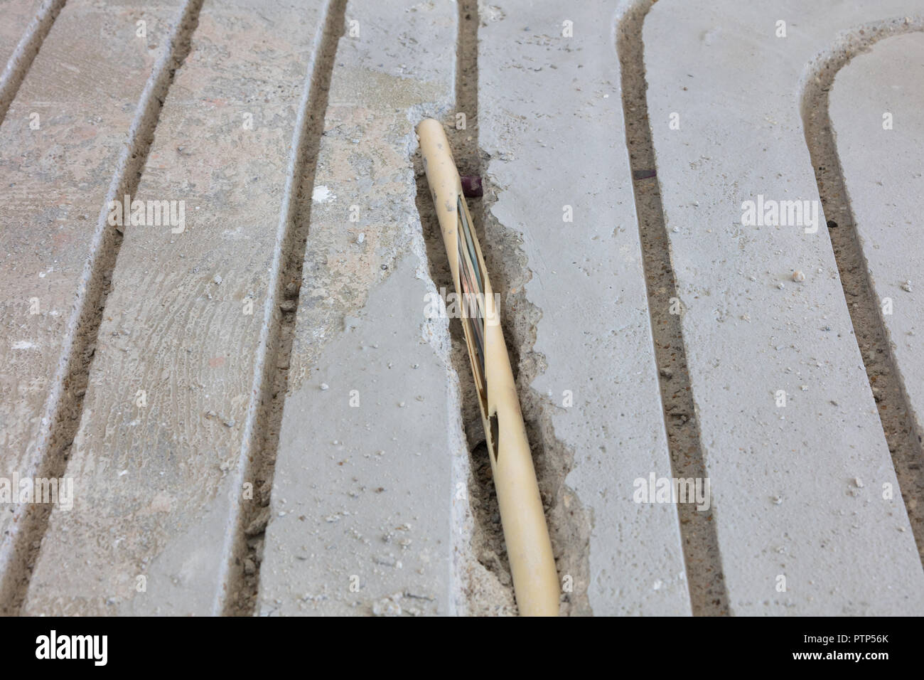 Broken wire in the floor, installing underfloor heating Stock Photo Alamy