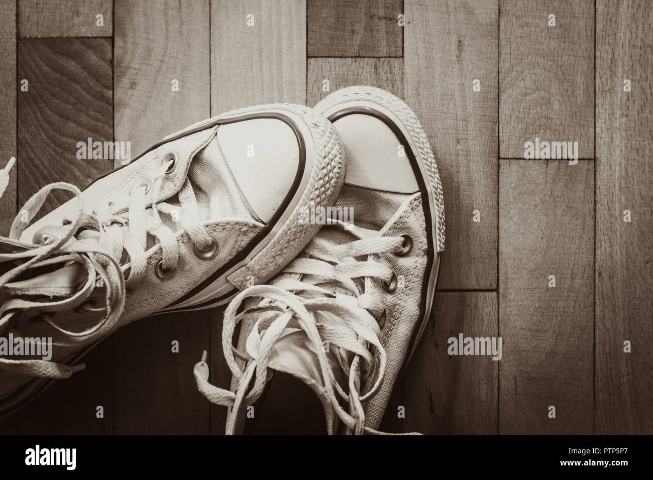 Old shoes on brown wood background Stock Photo - Alamy