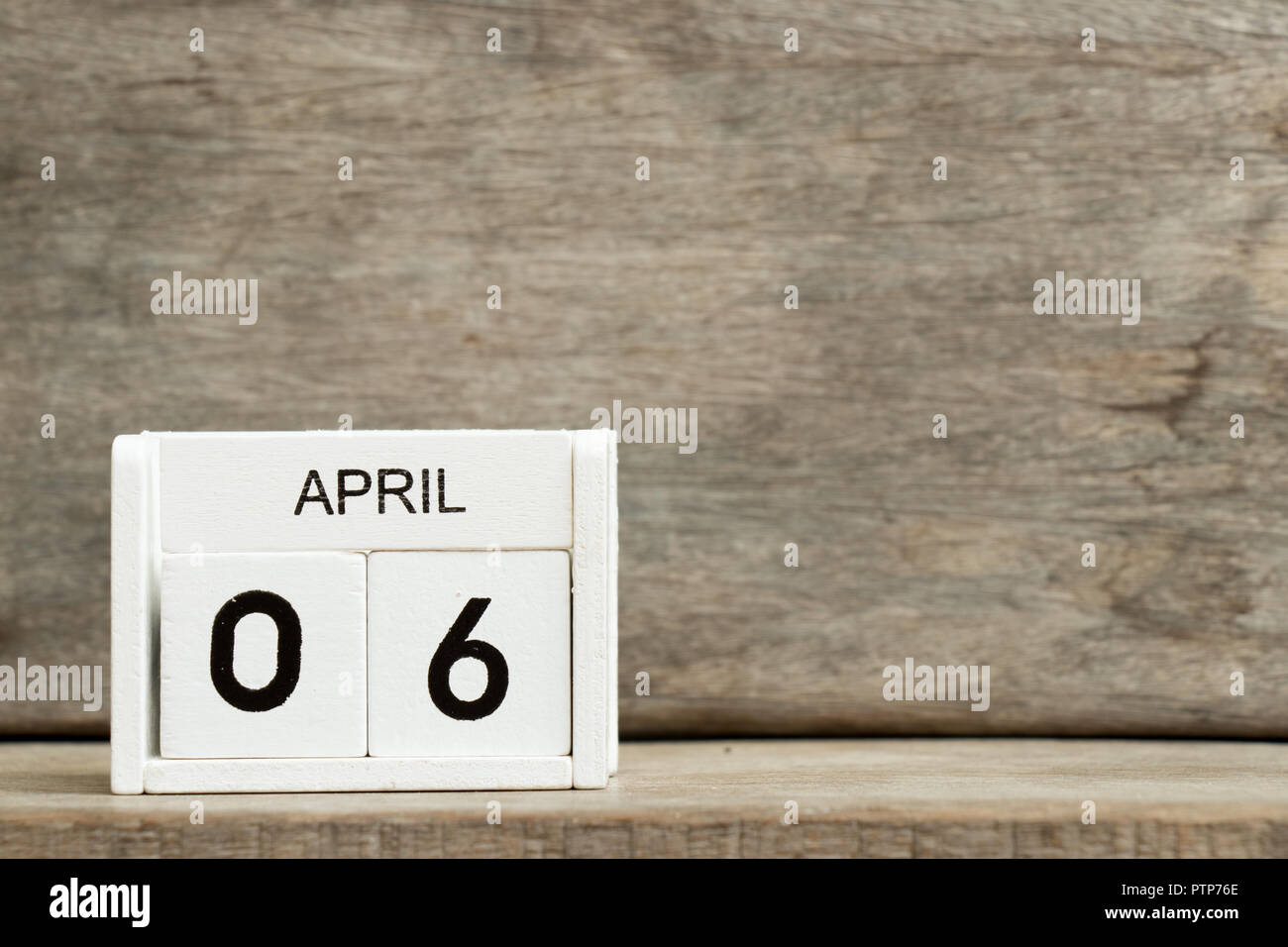 White block calendar present date 6 and month April on wood background Stock Photo