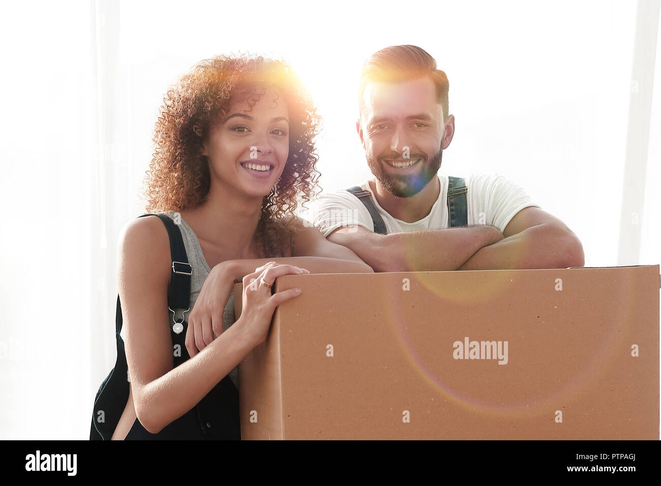 Happy couple honeymooners standing near boxes Stock Photo