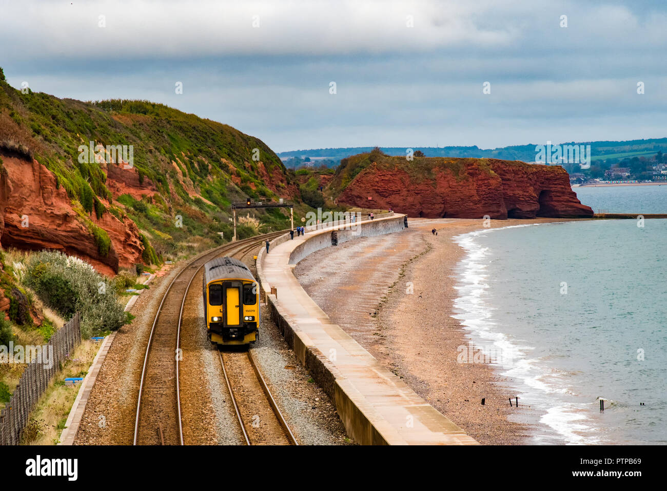 DAWLISH, DEVON, UK - 04OCT2018: GWR Class 150 Sprinter train  travelling south along the sea wall at Dawlish. Langstone Rock is in the background. Stock Photo