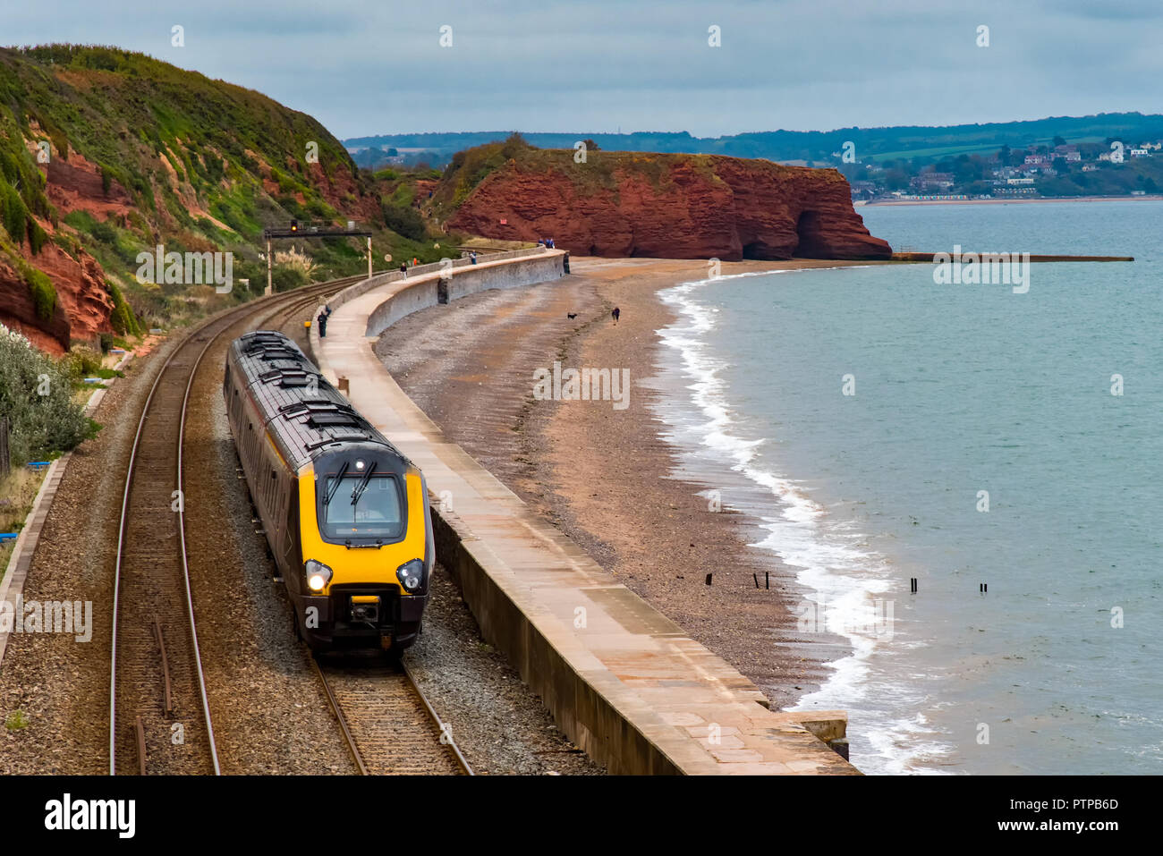 DAWLISH, DEVON, UK - 04OCT2018: Arriva Crosscountry Class  220 Voyager train  travelling south along the sea wall at Dawlish. Langstone Rock is in the Stock Photo
