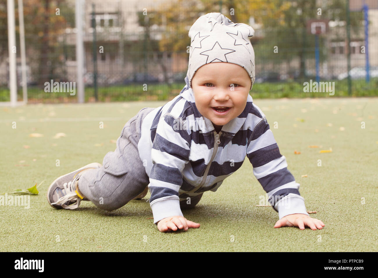 Smiling child playing outdoors, little boy 1-2 years old Stock Photo