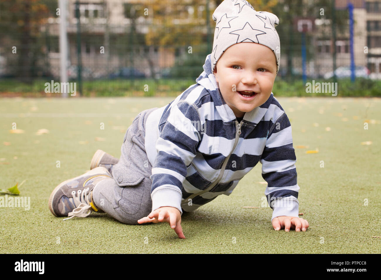 Child playing outdoors, little boy 1-2 years old Stock Photo