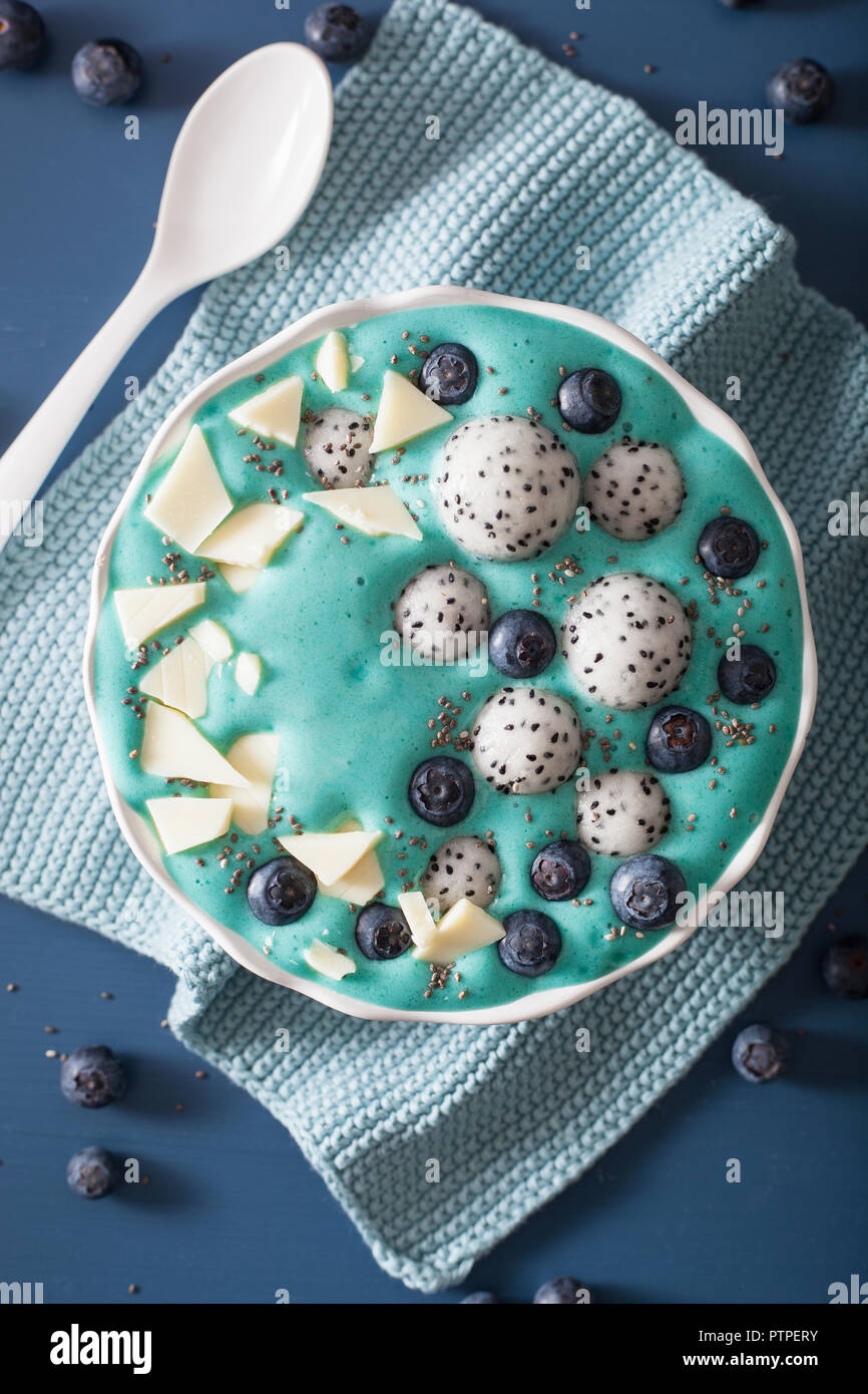 healthy blue spirulina smoothie bowl with blueberry, white chocolate