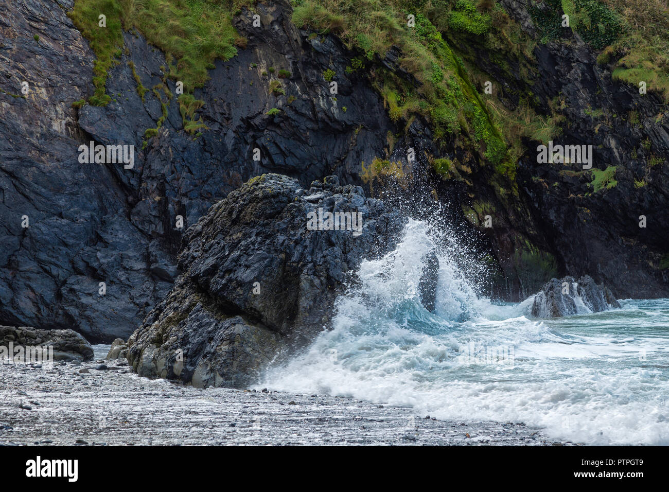 Waves breaking against rocks on the Pembrokeshire coast. Stock Photo