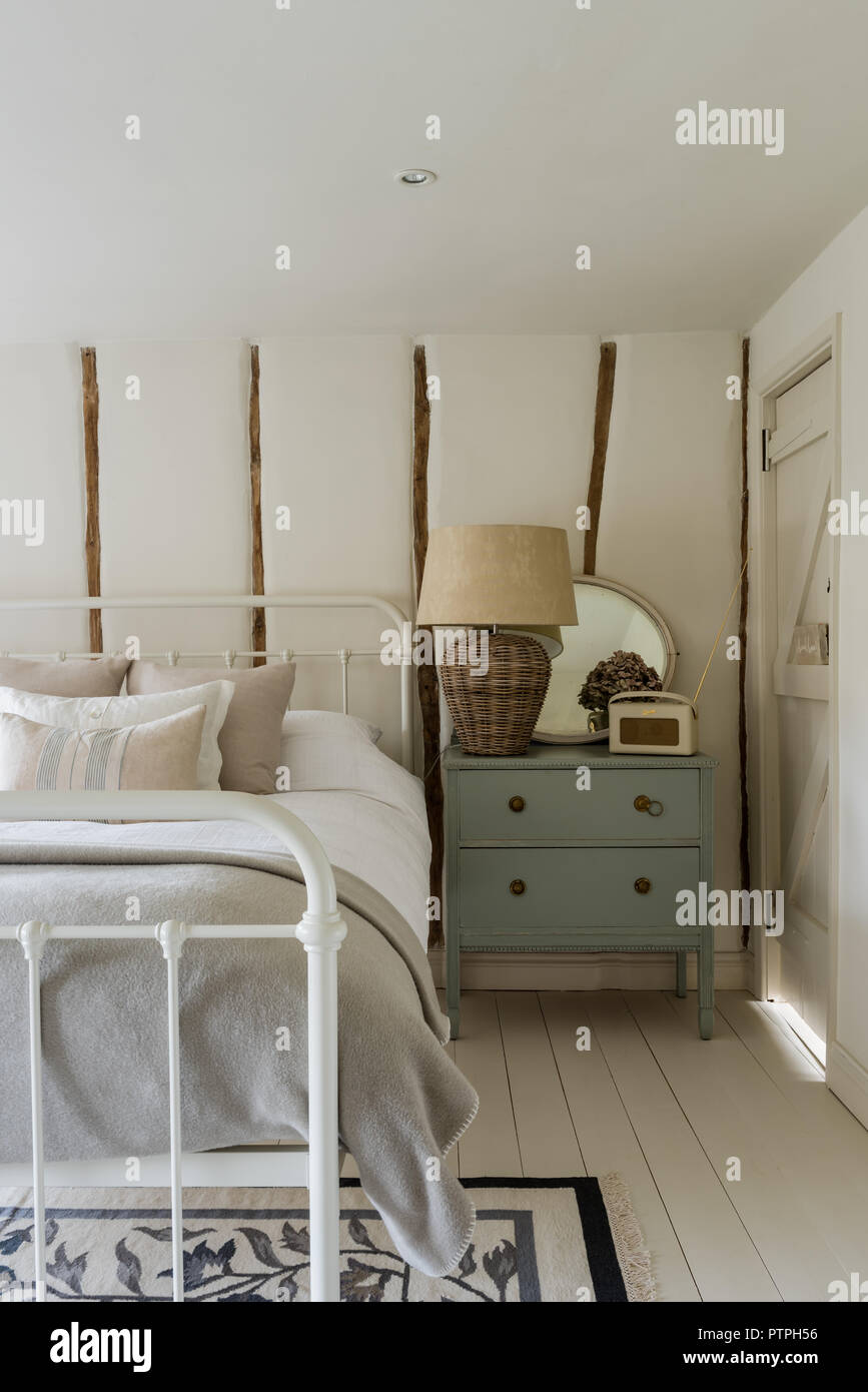 Traditional bed in cottage bedroom hires stock photography and images
