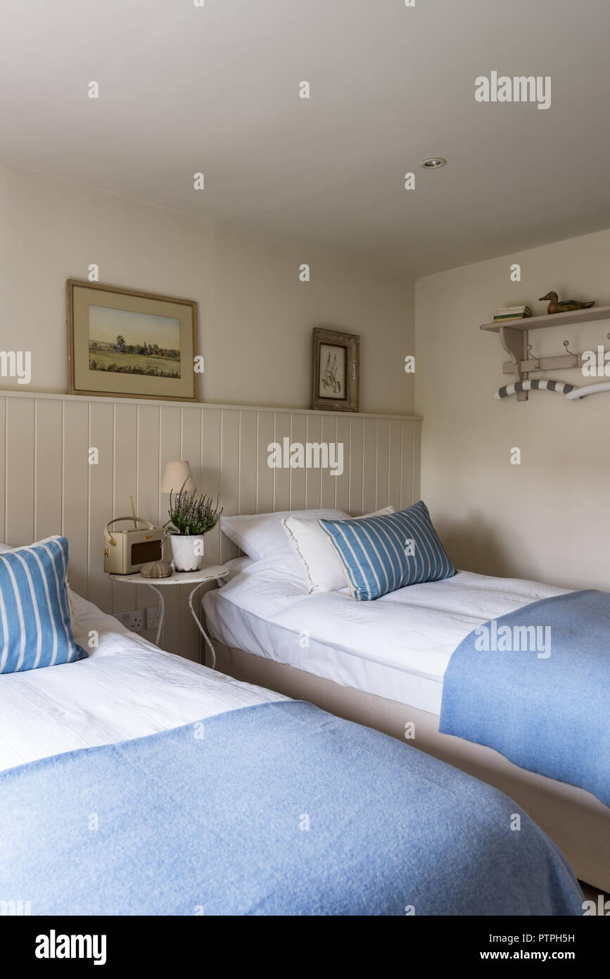 Twin beds with light blue blankets in 18th century Norfolk cottage Stock Photo
