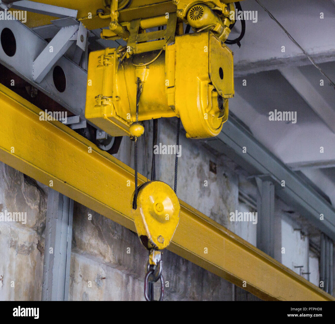 Yellow production crane beam, production crane for lifting cargo, close-up Stock Photo