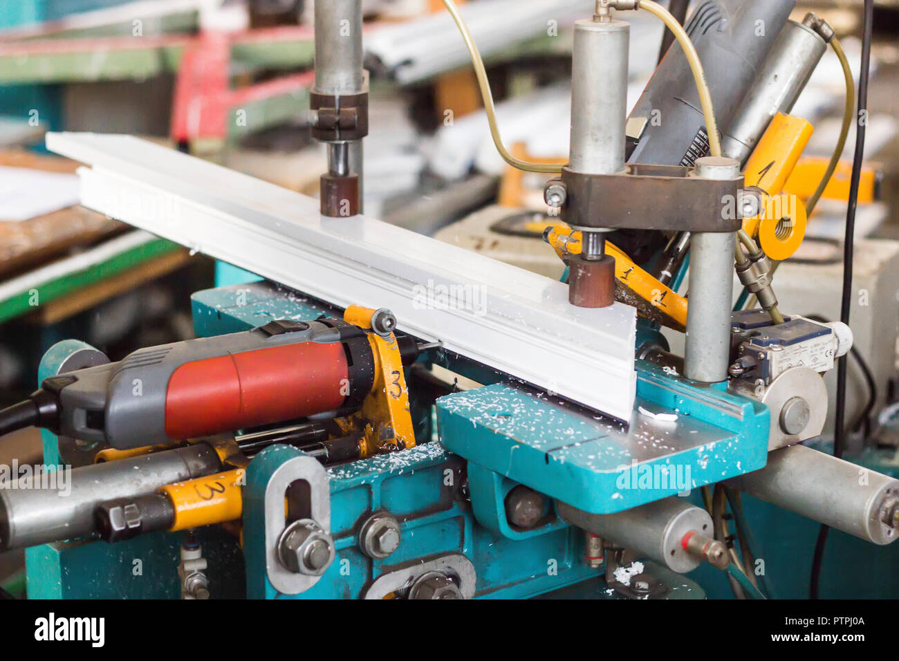 Production of PVC windows, a machine for making holes in the plastic