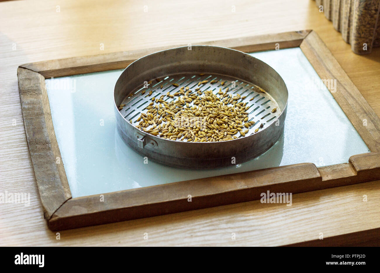 Laboratory for the inspection and analysis of grain, on the table lies a  sieve and grain, granule Stock Photo - Alamy