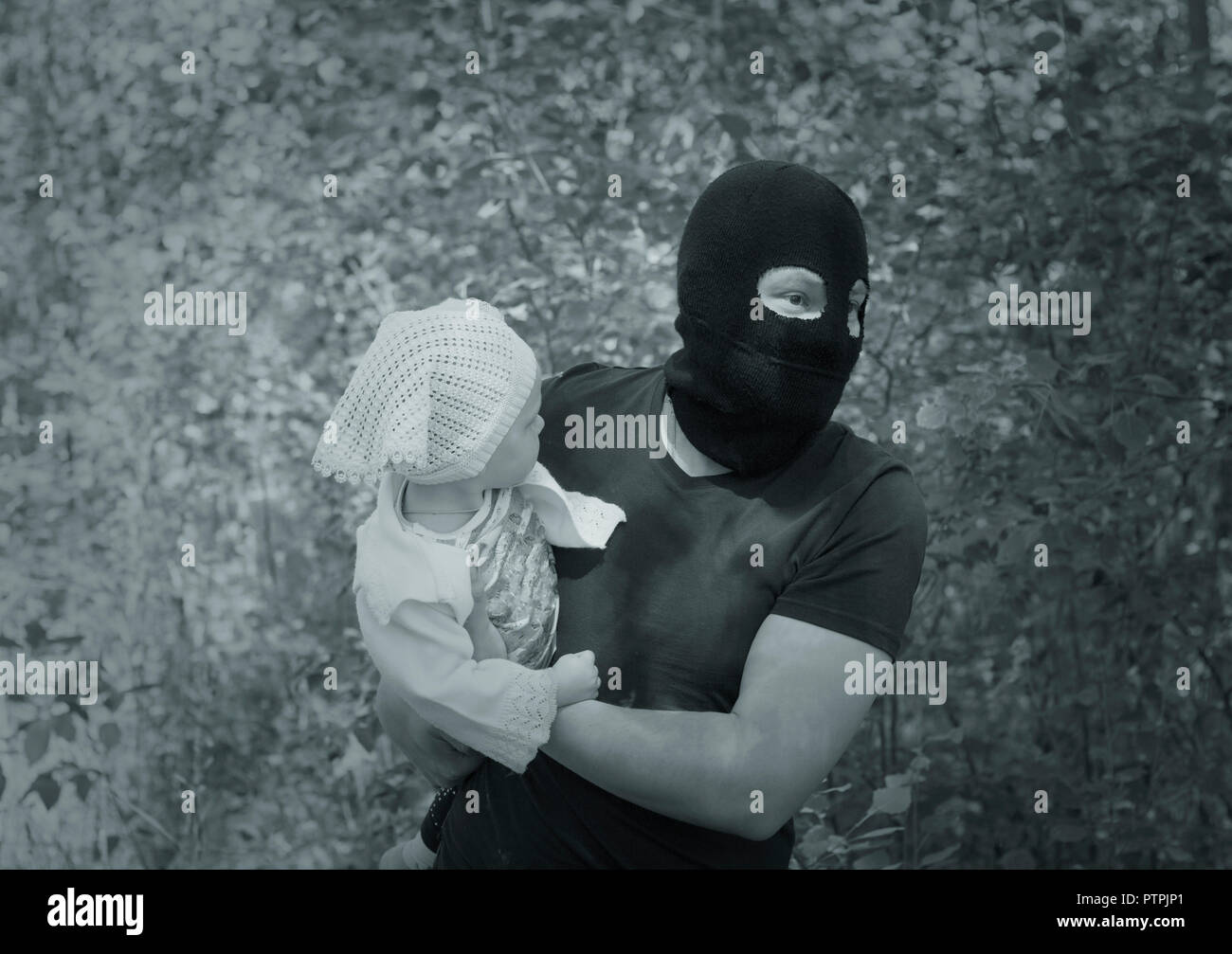 A man in black mask steals kidnapping child, close-up, black and white  Stock Photo - Alamy