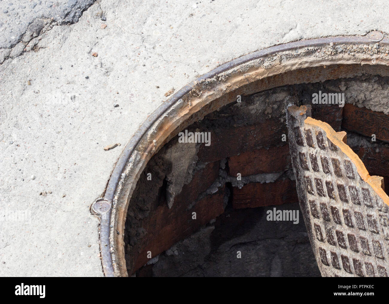 Broken sewer hatch, open drain hatch Stock Photo