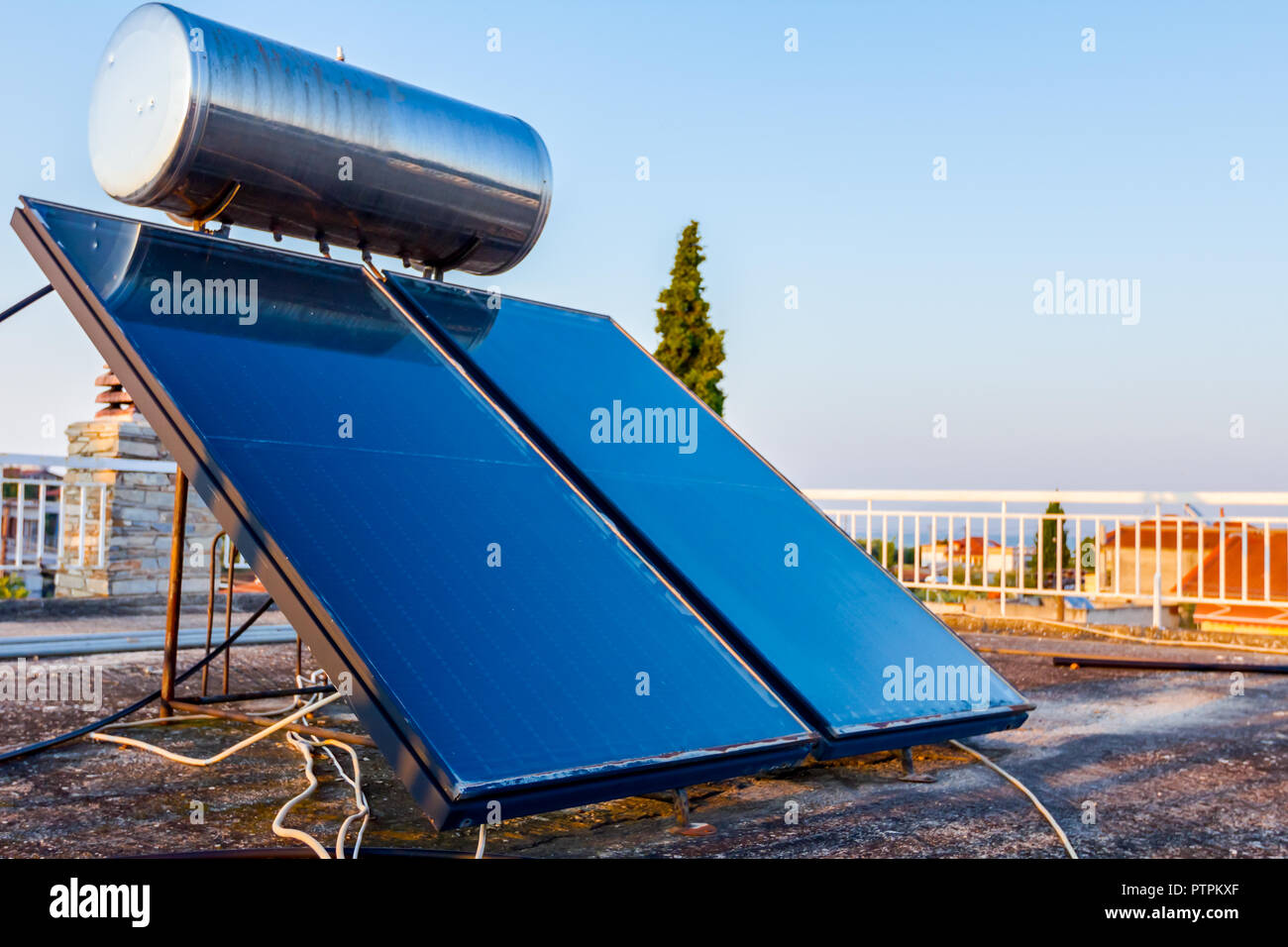 Water panels for using renewable sun energy are placed on house roof, solar hot water system. Modern energy saving technology Stock Photo