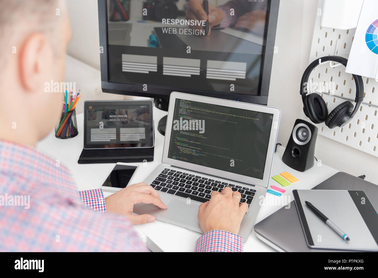 Programmer working on the code. IT specialist codes the responsive website Stock Photo