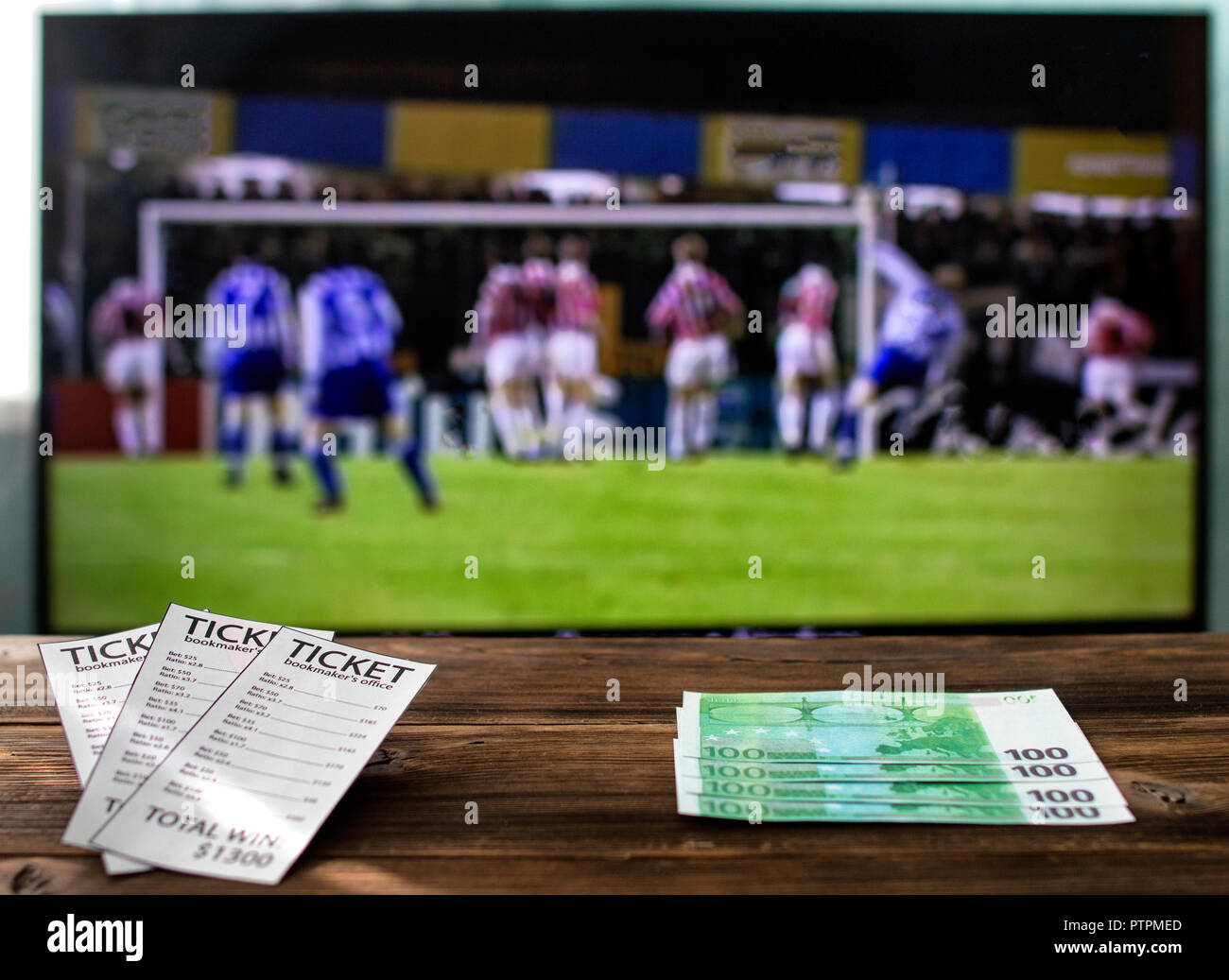 On the TV there is a league of champions on football on a table bookmaker's  tickets and euro, rates on sports Stock Photo - Alamy