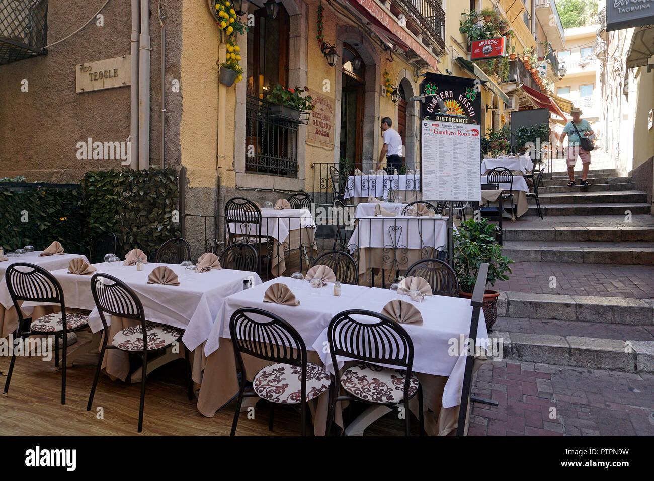 Idyllic restaurant at a alley of the old town of Taormina, Sicily, Italy Stock Photo