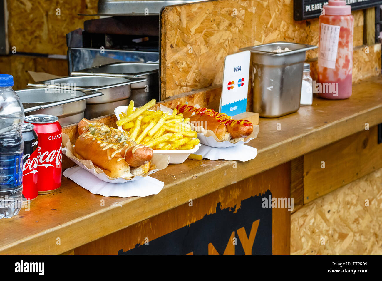 London, UK - September 1, 2018 - Hot dogs and chips on display at Camden Market Stock Photo