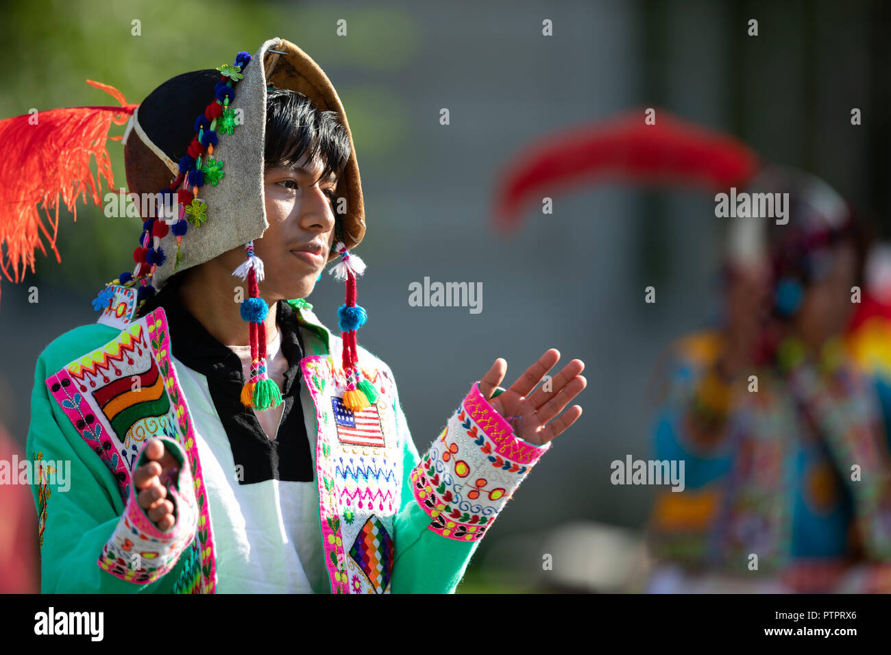 Washington, D.C., USA - September 29, 2018: The Fiesta DC Parade, young man from bolivia wearing traditional clothing walking down the street during t Stock Photo