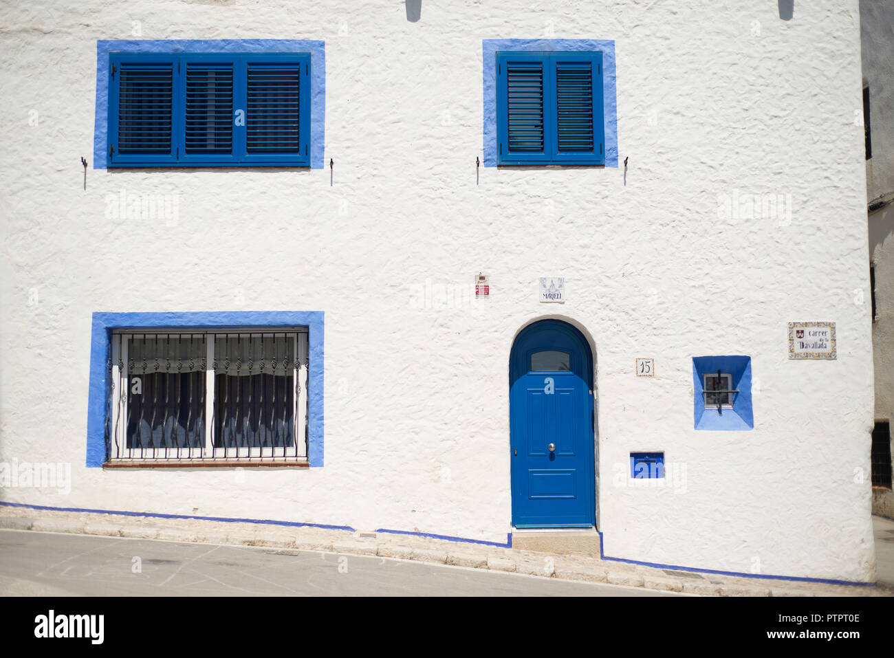 Blue and white typical facade of a house in the Mediterranean town of Sitges, Catalonia Stock Photo