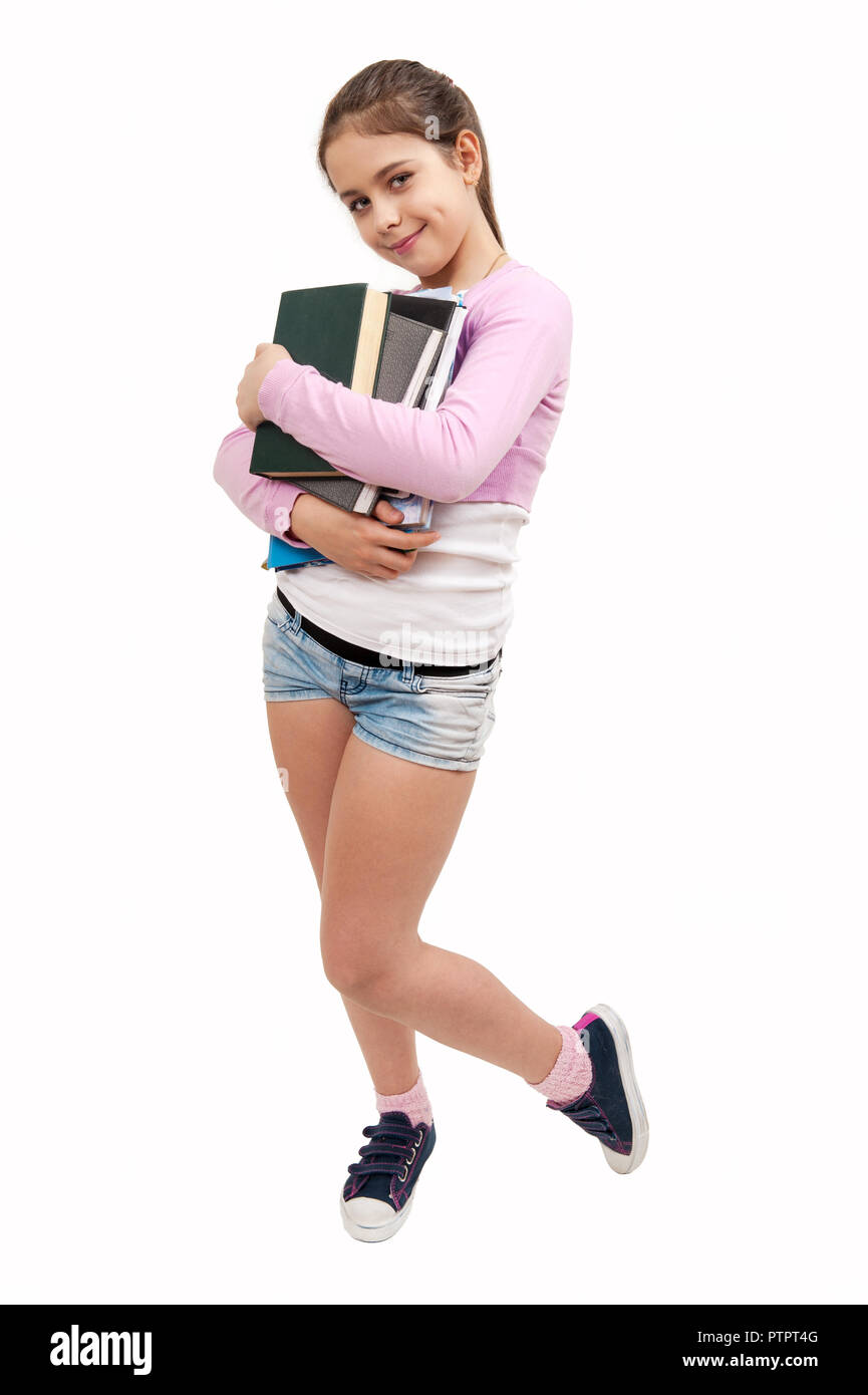 Girl schoolgirl with a stack of books on a white background Stock Photo ...