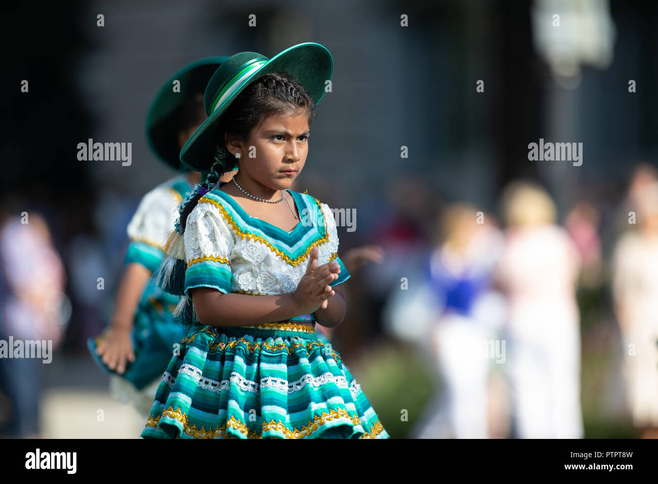 Washington, D.C., USA - September 29, 2018: The Fiesta DC Parade, Young Bolivian girl wearing traditional clothing going down the street during the pa Stock Photo