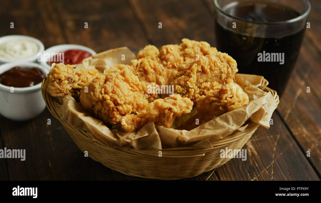 Fried chicken wings near sauces and drink Stock Photo Alamy