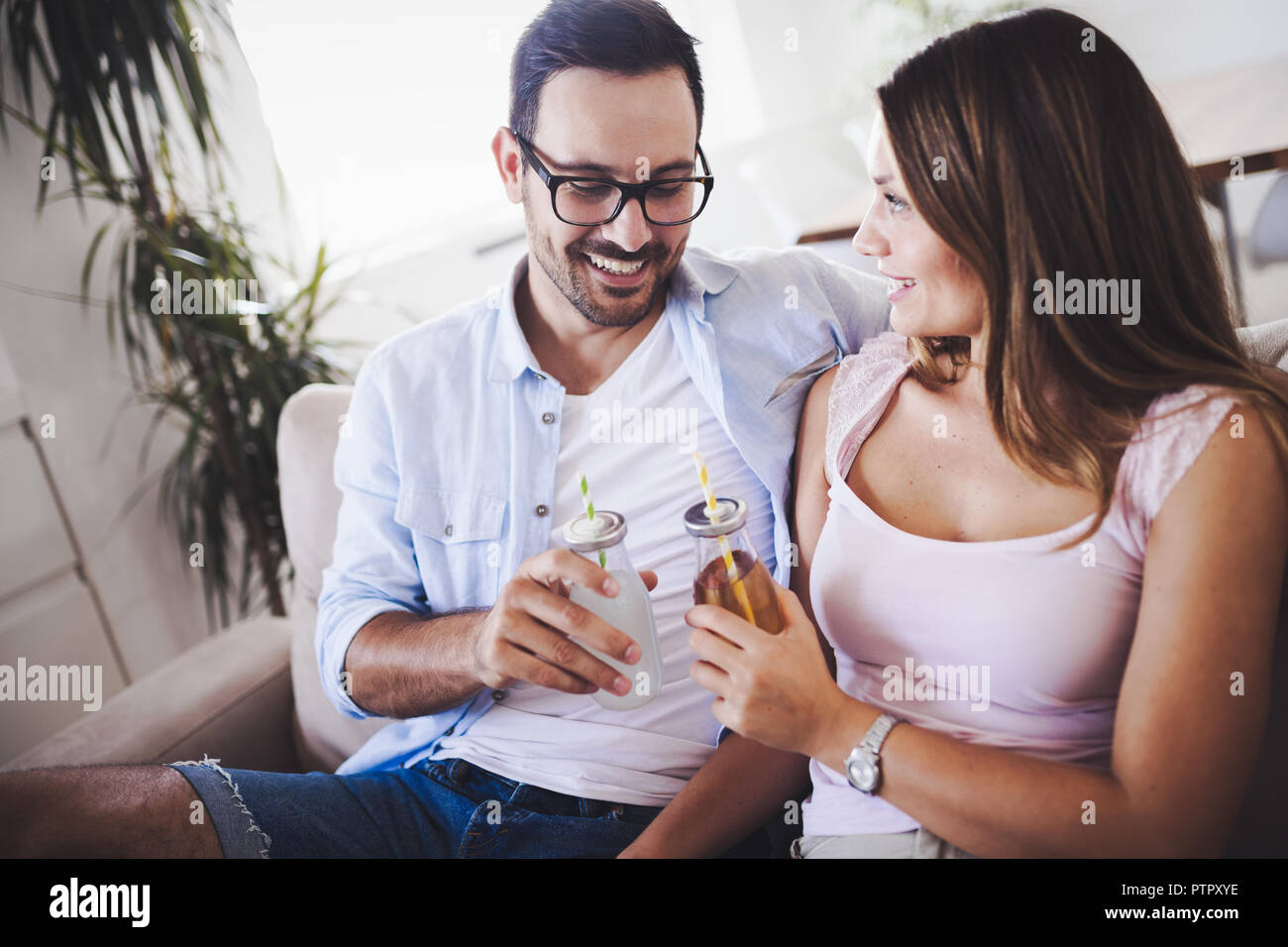 Happy attractive couple drinking together at home Stock Photo