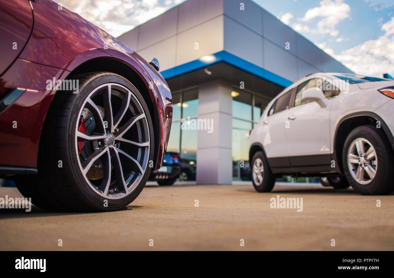 Automotive Dealership Store. New and Pre Owned Vehicles in Front of the Showroom Building. Stock Photo